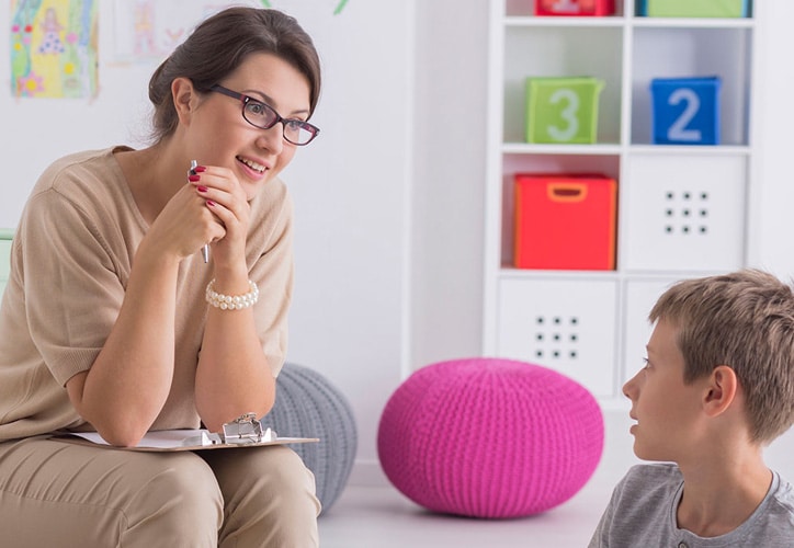 Woman Psychologist Talking to Boy